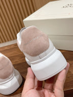 Tan suede and white leather sneaker heel with cushioned collar