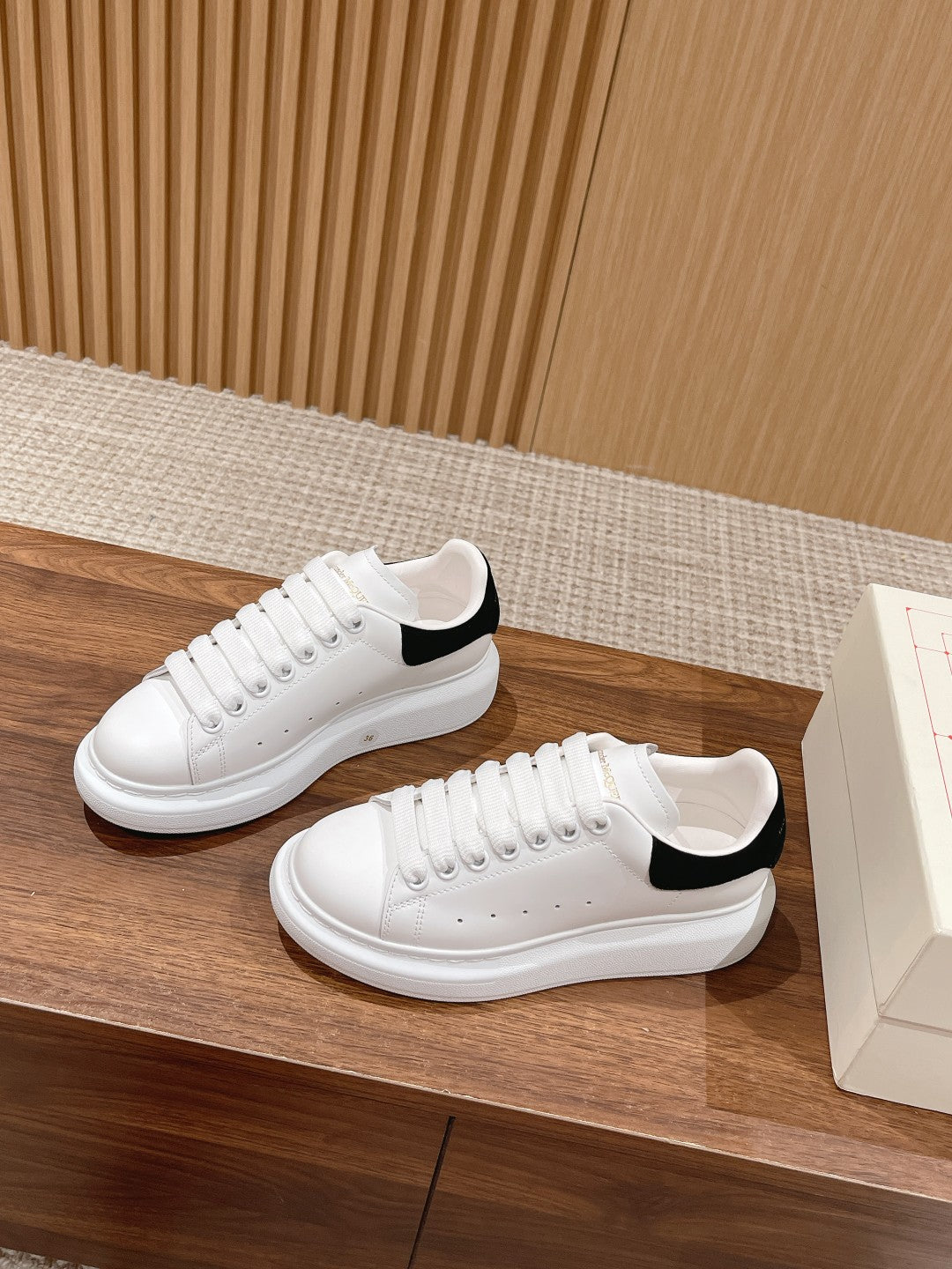 Alexander McQueen white sneakers with black collar trim and perforated toe