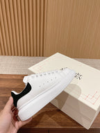 Alexander McQueen white leather sneakers with black heel tab and lace-up front