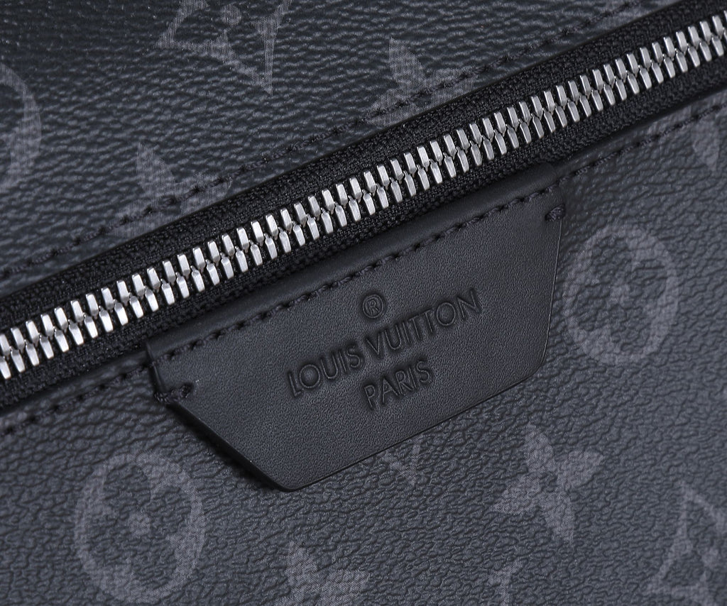 Black Louis Vuitton monogram zip pocket with embossed “Louis Vuitton Paris” label