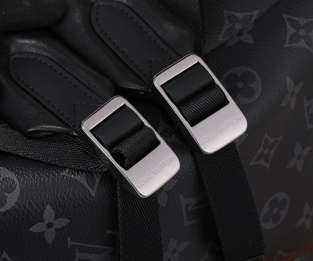 Black Louis Vuitton monogram bag with webbing strap and silver-tone metal buckle
