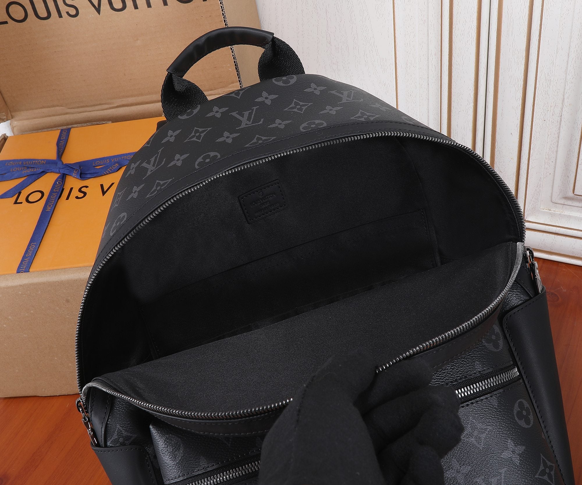 Louis Vuitton monogram backpack with curved zipper opening and front zip compartment