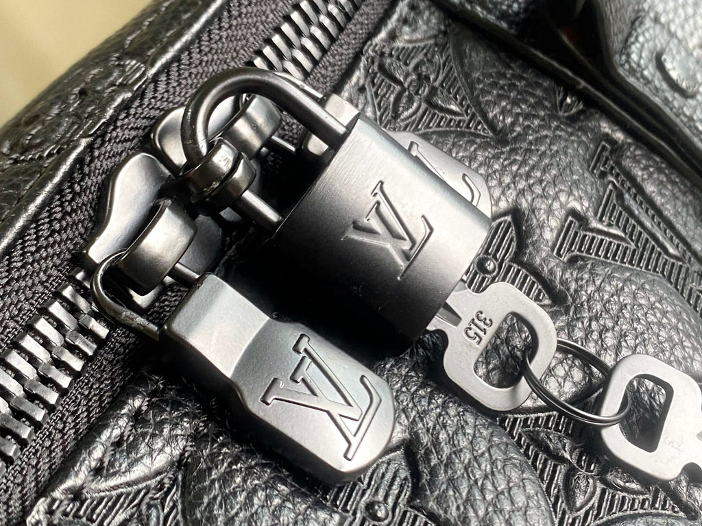Louis Vuitton duffel bag zipper pulls with logo on dark leather