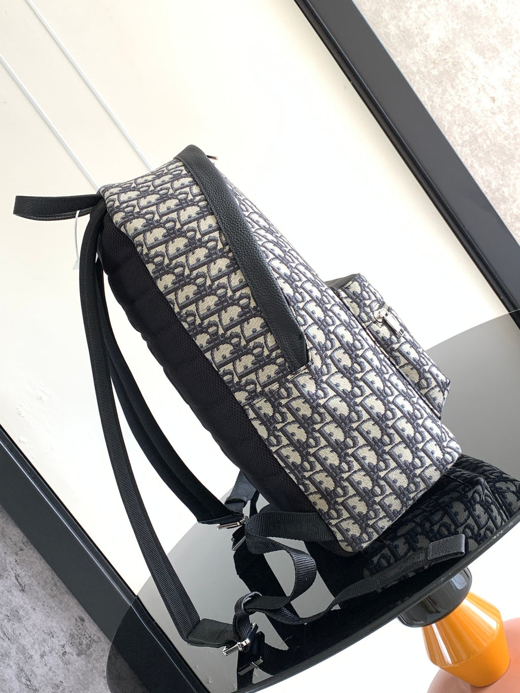 Dior monogram backpack bag with side strap details and front zip, black trim