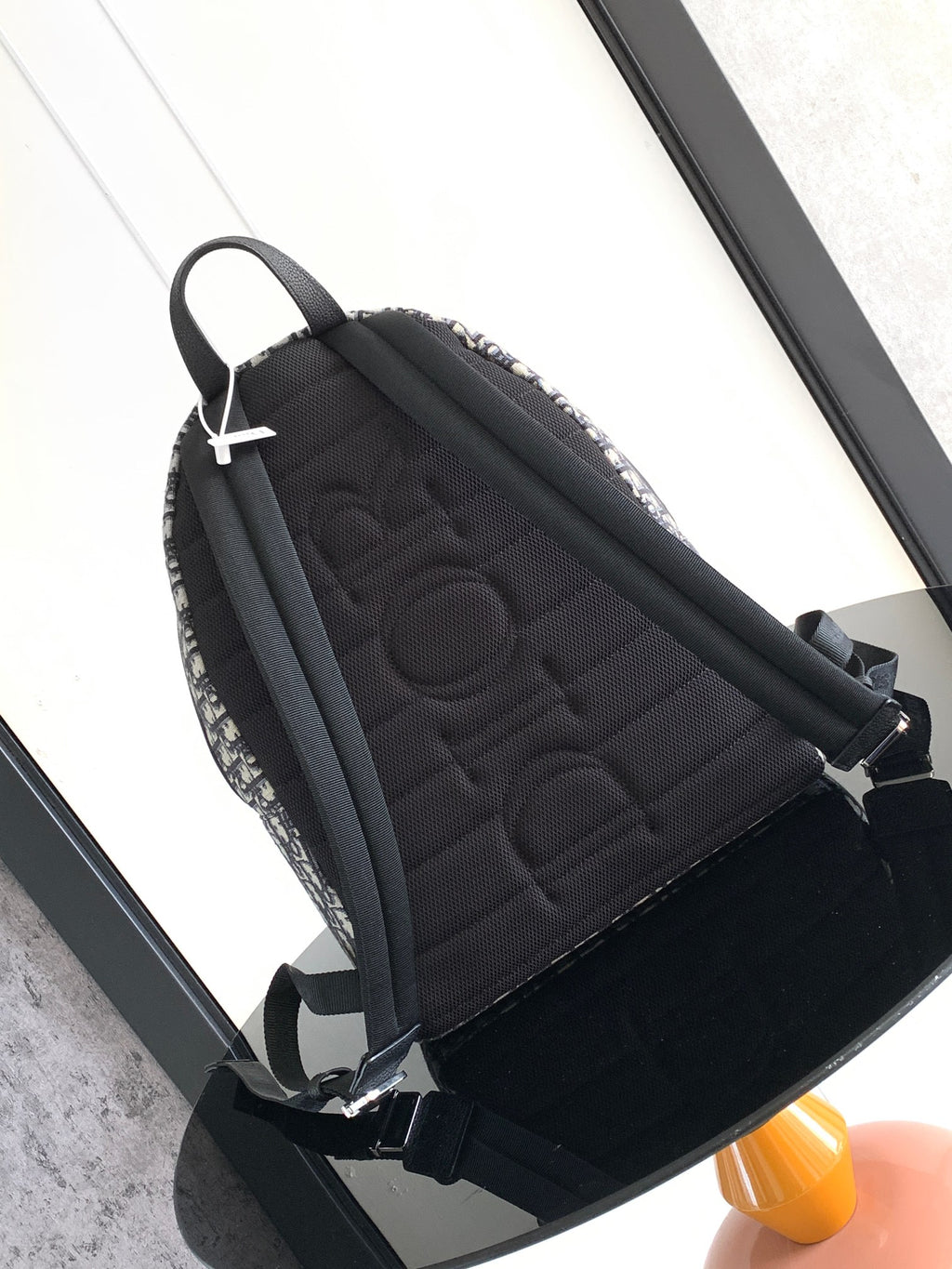 Men's Dior backpack back panel with quilted black fabric and black shoulder straps