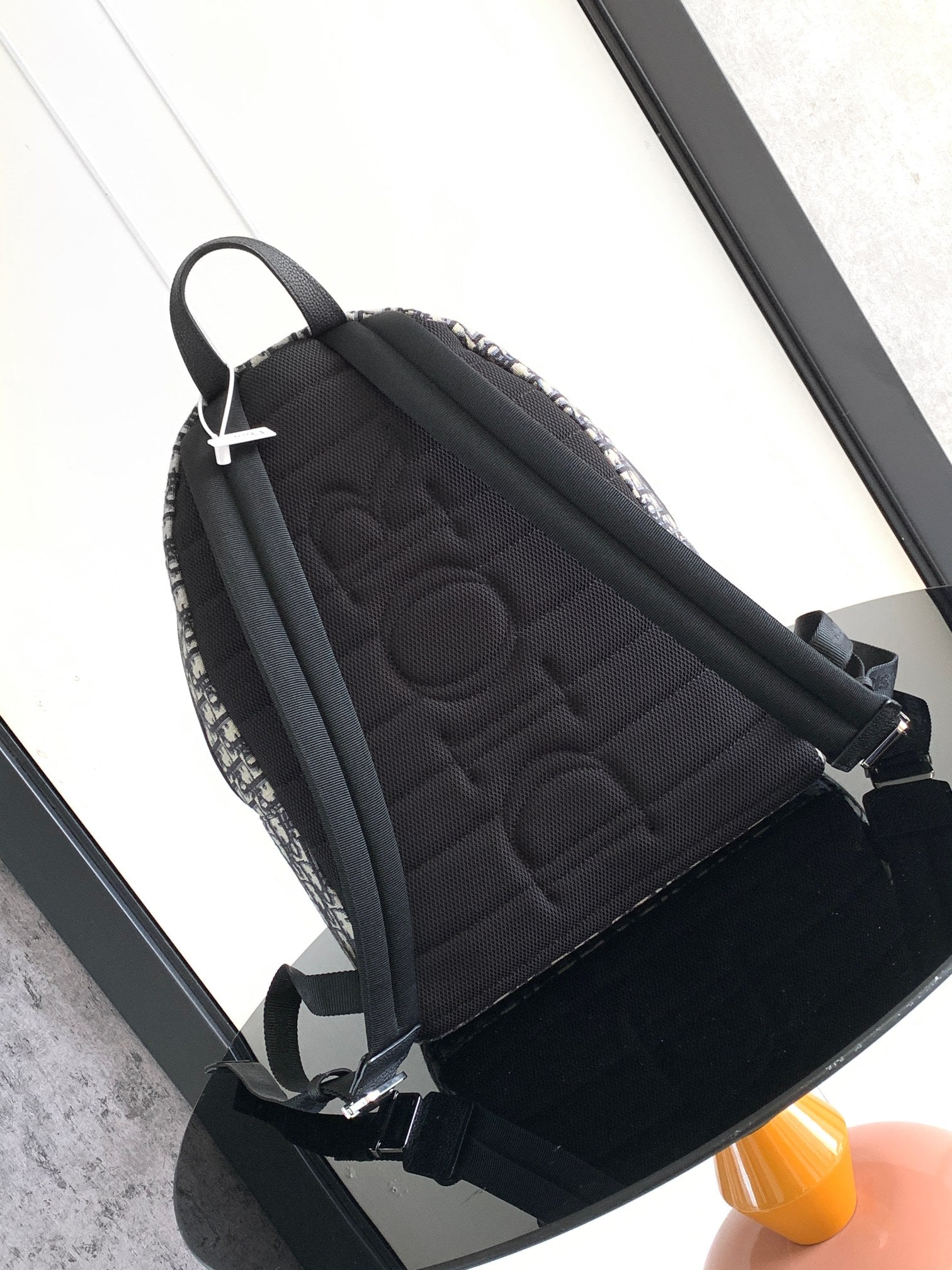 Men's Dior backpack back panel with quilted black fabric and black shoulder straps