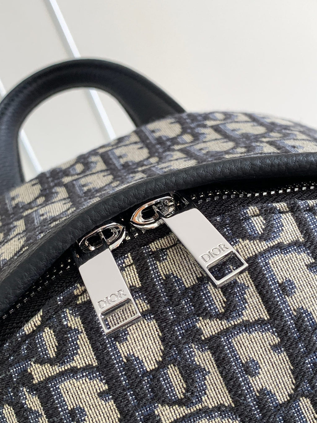 Dior monogram backpack with silver-tone zipper pulls and Dior label on tabs