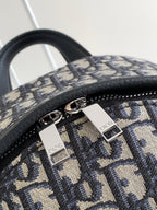 Dior monogram backpack with silver-tone zipper pulls and Dior label on tabs