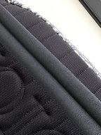 Close-up of black mesh lining inside Dior bag with stitched edges