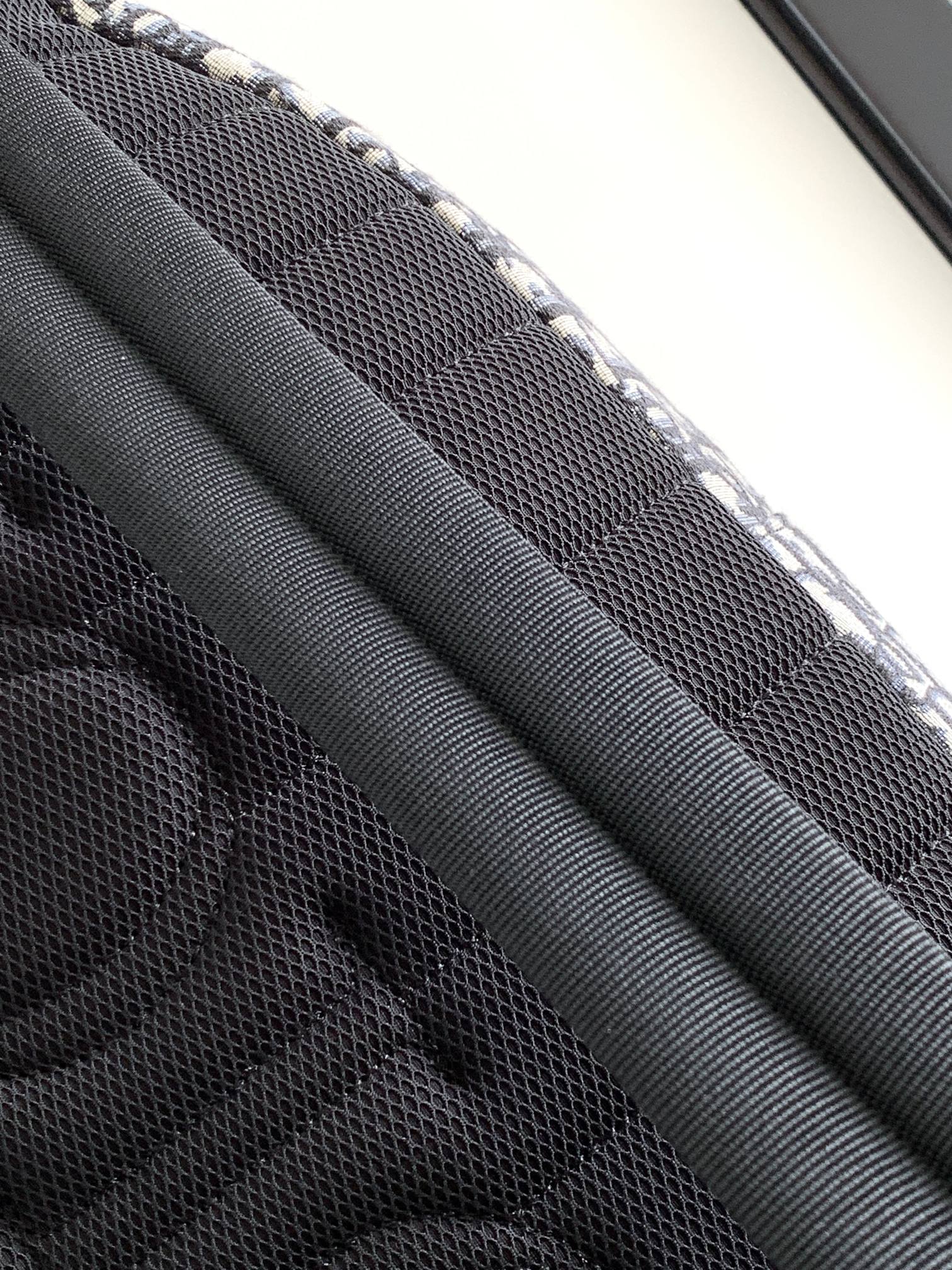 Close-up of black mesh lining inside Dior bag with stitched edges