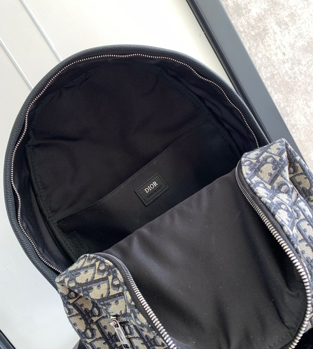 Dior monogram backpack bag interior with black lining and zip pocket compartments