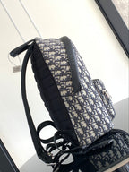 Dior men backpack with dark blue and beige monogram canvas and padded black shoulder straps