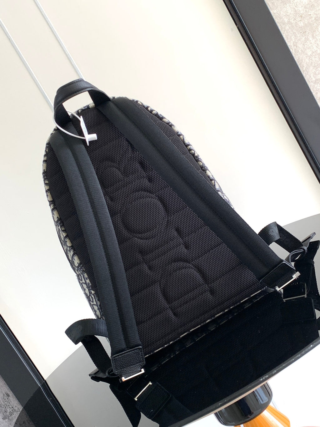 Dior men backpack with quilted black back panel and dark blue monogram canvas sides