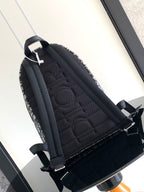 Dior men backpack with quilted black back panel and dark blue monogram canvas sides