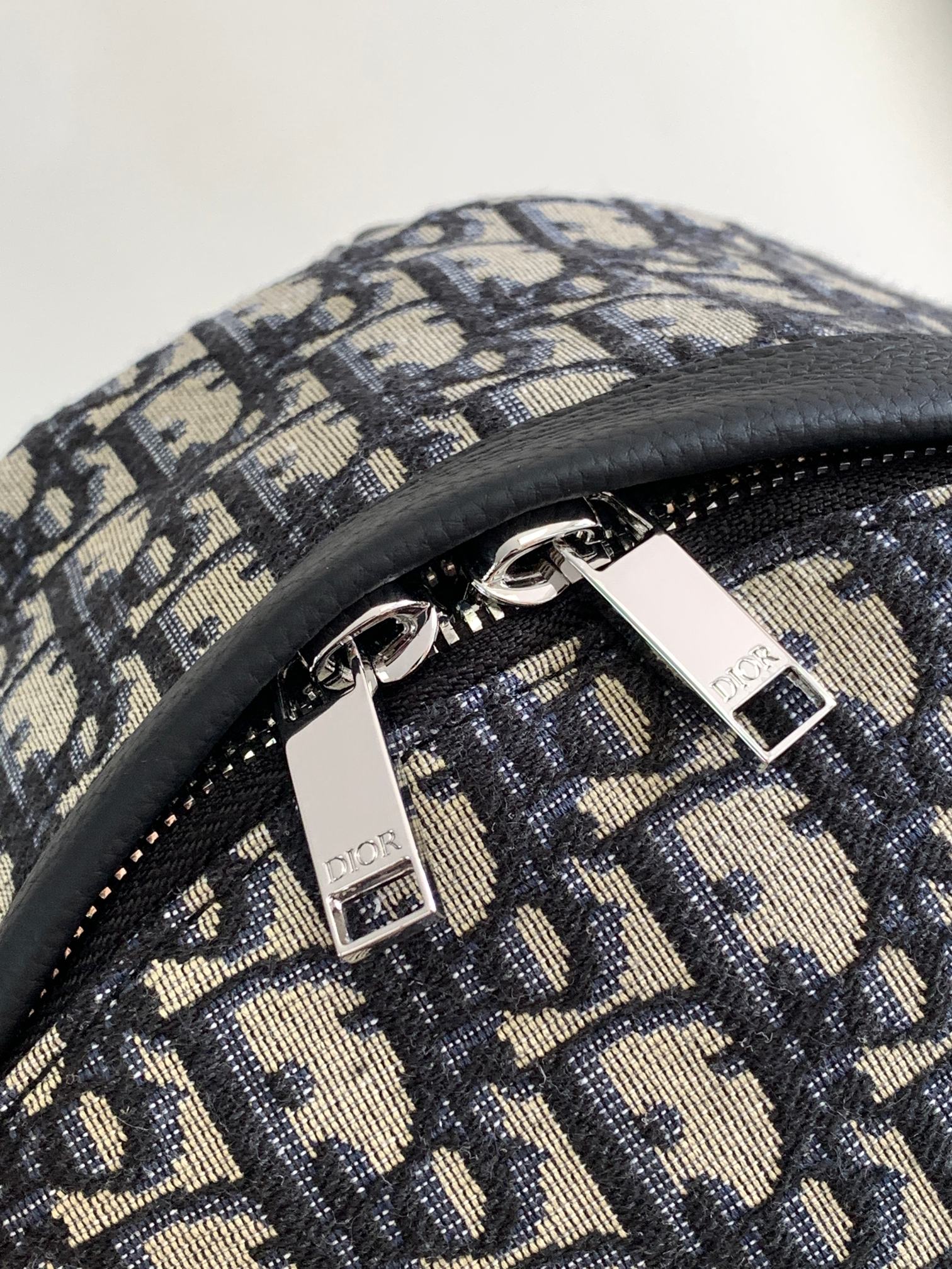 Dior men backpack metal zipper pulls on dark blue and beige monogram canvas
