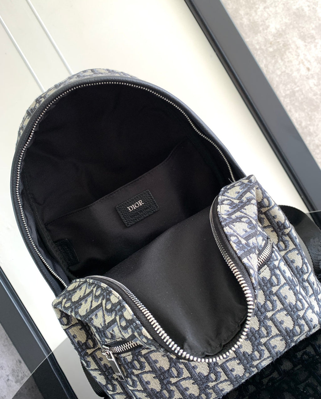 Dior men backpack open top with black fabric lining and monogram canvas exterior