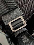 Men's Dior backpack strap hardware with metal buckle and black leather detail
