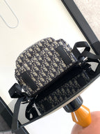 Dior men's mini backpack front view in blue-and-cream monogram canvas with top zip
