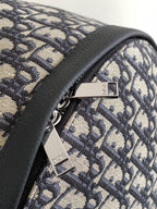 Dior monogram backpack corner with adjustable strap and logo plate hardware.