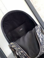 Dior men's mini backpack open interior with black lining and zippered main compartment