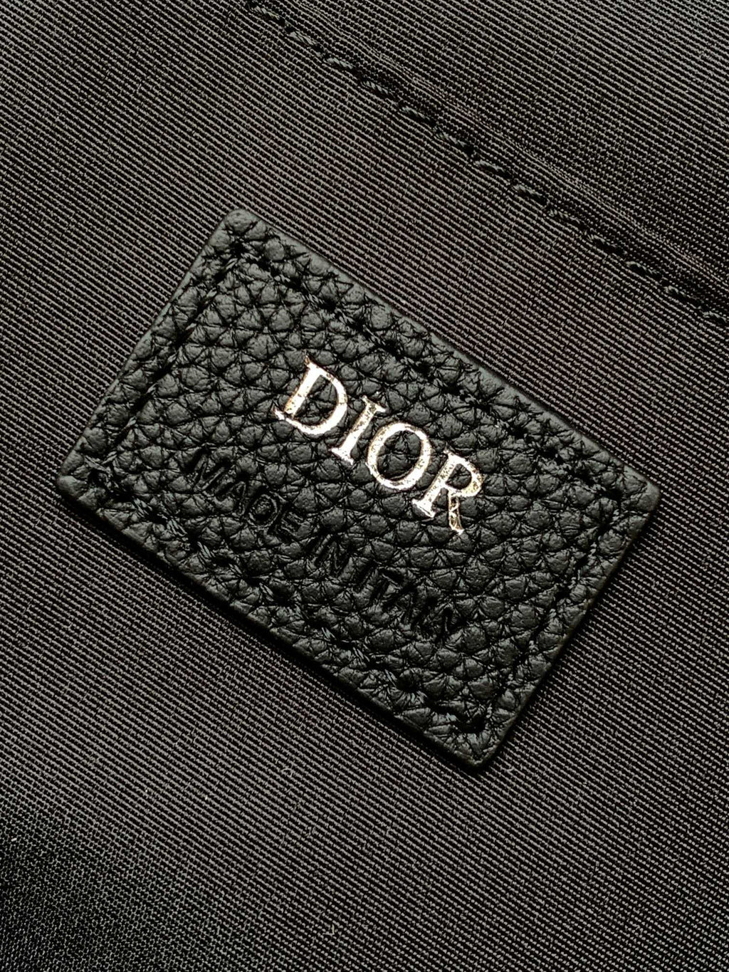 Men's Dior backpack interior label in textured black leather with Dior logo