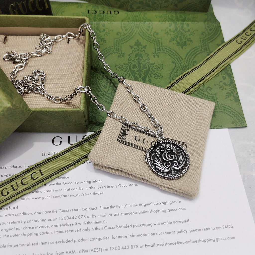 Silver-tone round logo medallion pendant necklace on a chain
