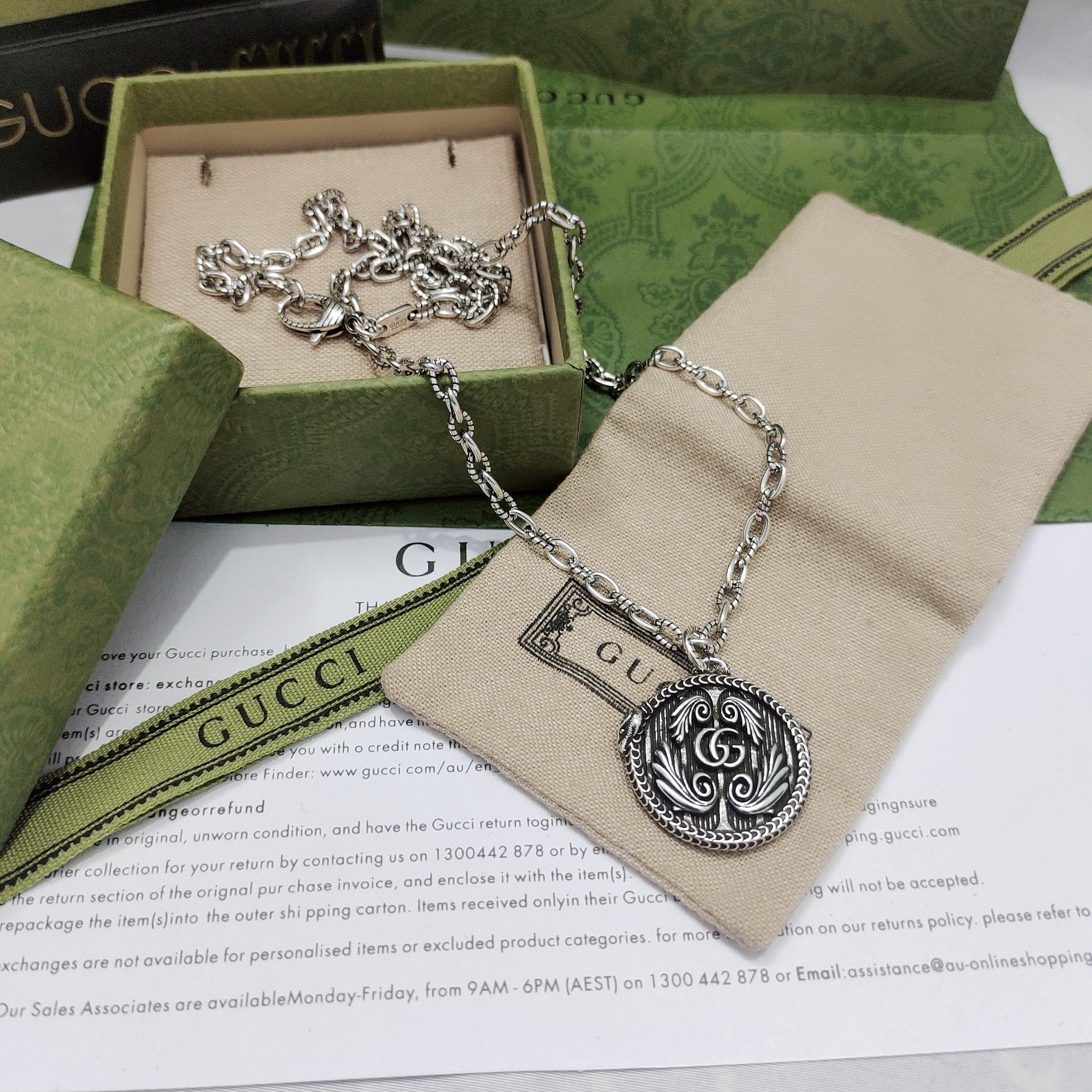 Silver-tone pendant necklace with round engraved logo medallion