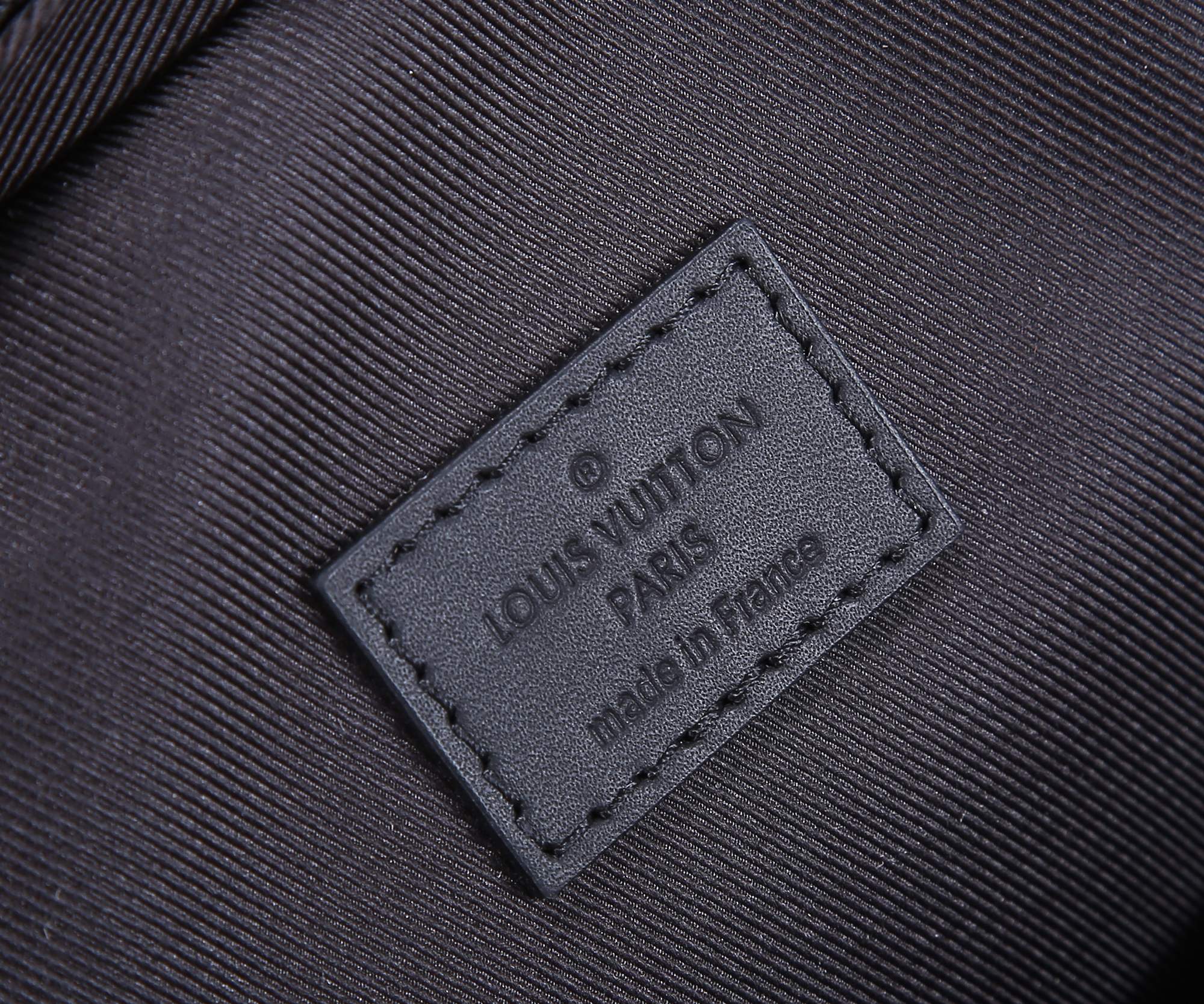 Louis Vuitton inner label patch stitched on dark fabric lining