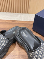 Dior monogram slide sandals, close-up of black footbed and patterned strap