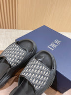 Dior monogram slide sandals with black strap and patterned band, on Dior shoebox