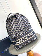 Dior men's backpack with navy and cream Dior monogram print, top handle and drawstring