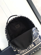 Dior men's backpack open top with black lined interior and logo webbing trim