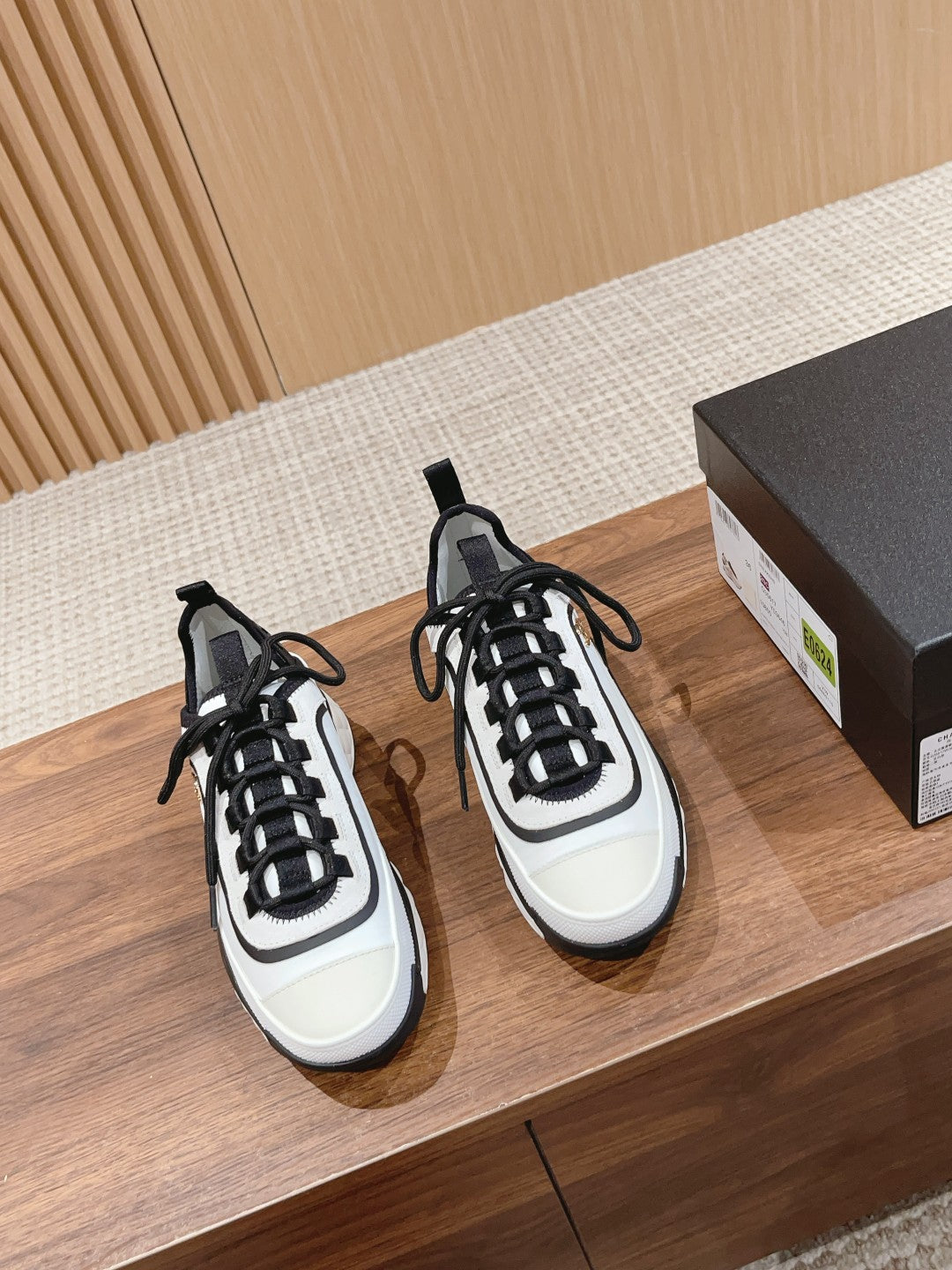 Black and white unisex sneakers with black laces and rubber toe cap