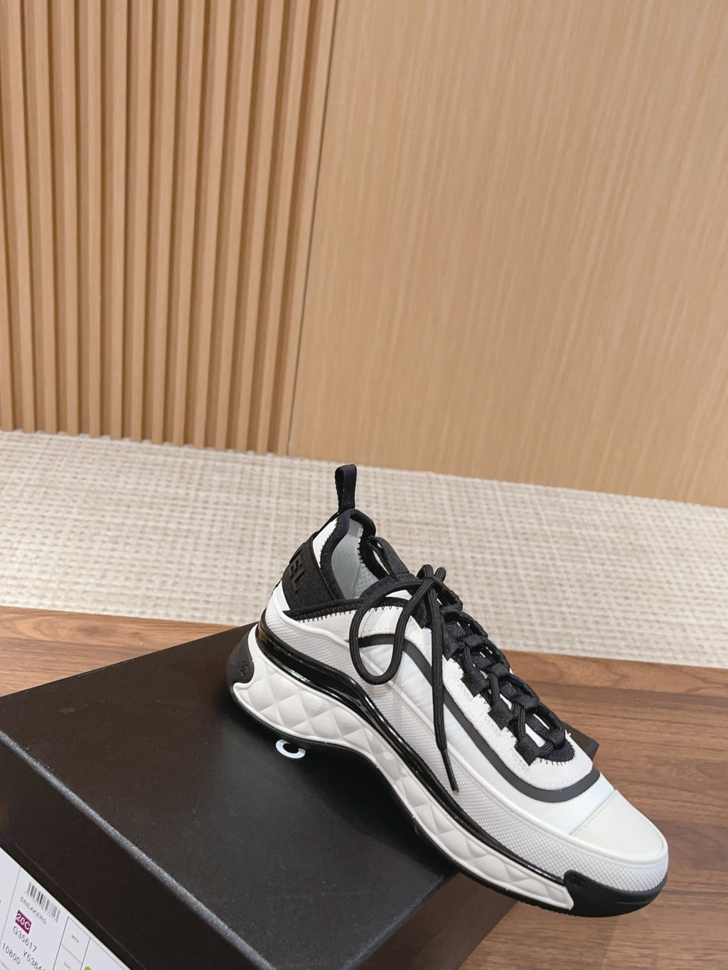 White and black unisex sneakers with black laces and side stripe detail