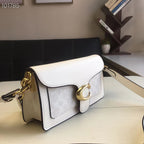 Coah white crossbody bag with gold chain strap, curved flap, and gold clasp ring