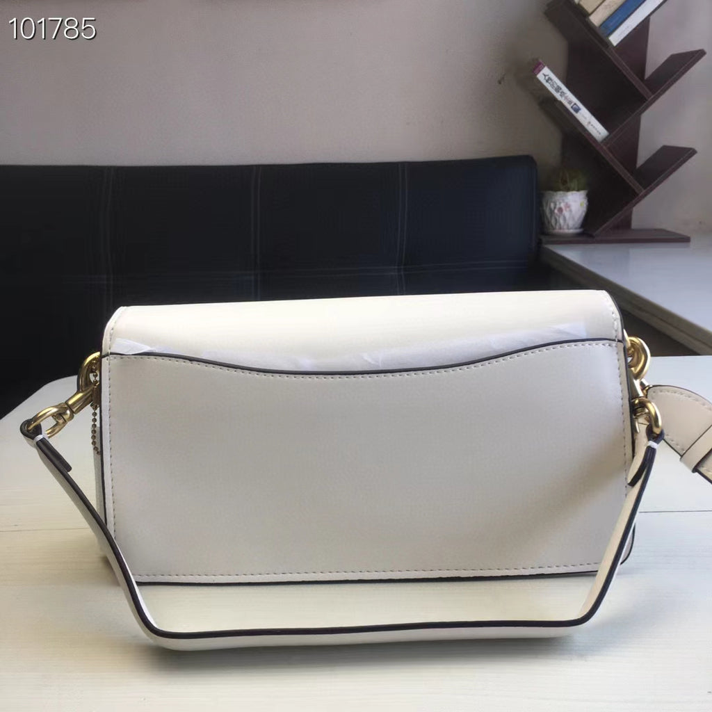 Coah white shoulder bag with rectangular shape, gold chain, and flap closure