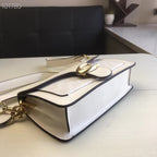 Coah white shoulder bag angled view with gold buckle clasp and chain strap