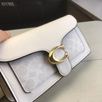 Coah white bag close-up of front flap and textured panel with gold turn-lock