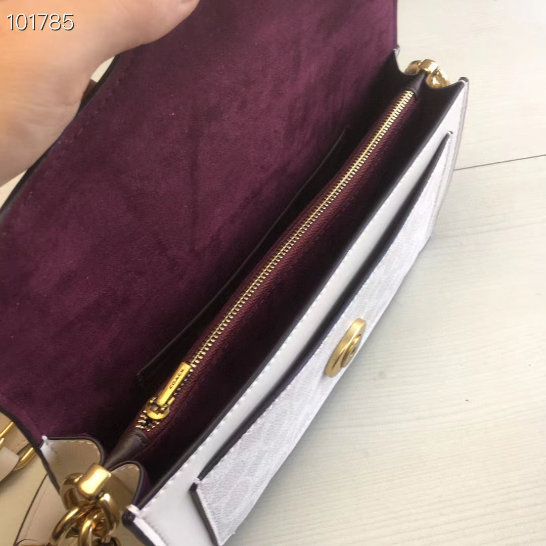 Coah bag interior view with burgundy lining and gold zipper along the side
