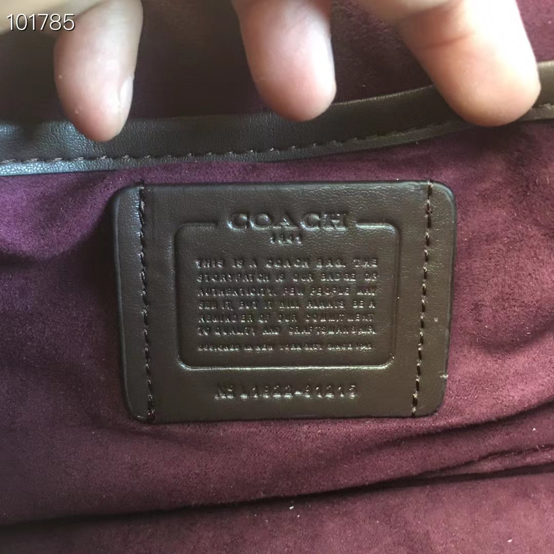 Coah bag leather logo patch on burgundy lining, with embossed text
