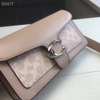 Coah bag close-up with logo tab, metal ring buckle, taupe leather trim and flap.