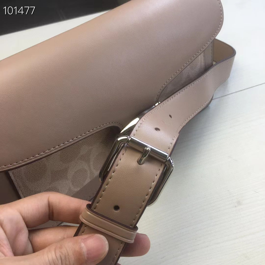 Coah bag strap end detail with buckle and adjustment holes, taupe leather.