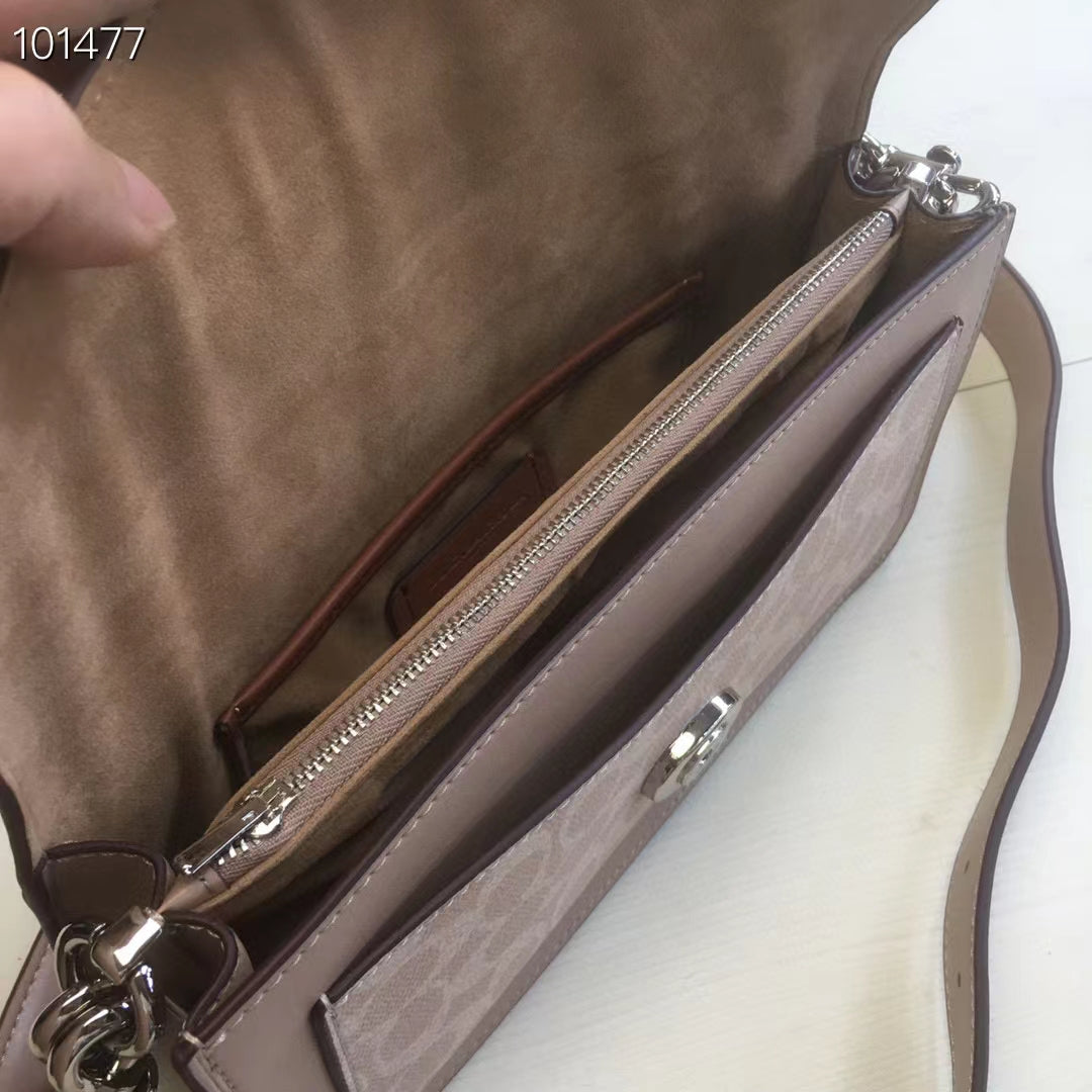 Coah bag interior side view with zipper pocket and logo canvas lining, taupe trim.