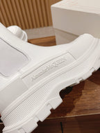 White Chelsea boot side close-up with Alexander McQueen logo on the sole edge