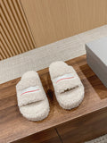 White shearling slide sandals with red logo stripe on the front strap