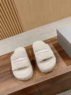 White shearling slide sandals with red logo stripe on the front strap