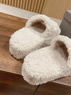 White shearling slide sandals with open top and padded front strap