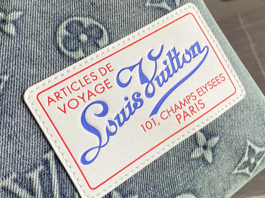 Louis Vuitton luggage label patch on blue fabric, red border and blue logo text