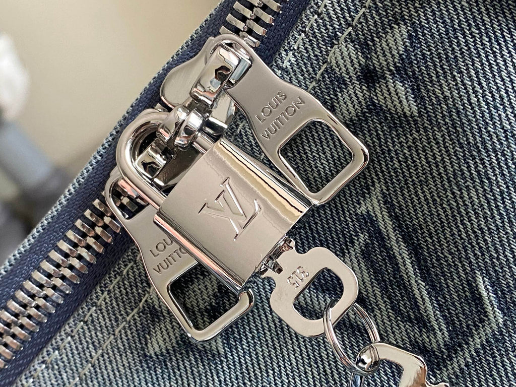 Louis Vuitton men’s bag, silver zipper pulls and keyring hardware on blue fabric