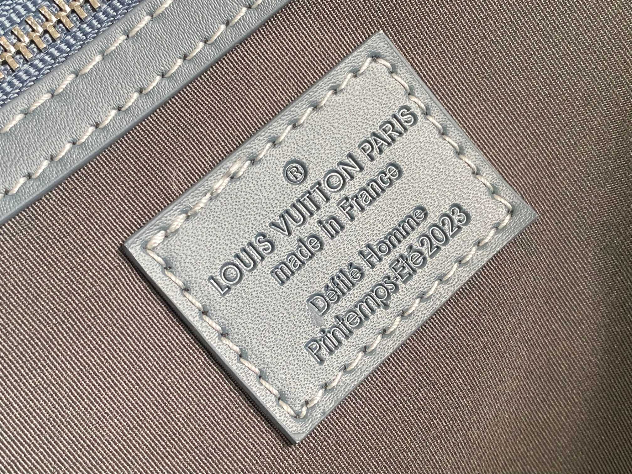 Louis Vuitton authenticity label on beige fabric with 'made in France' text
